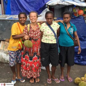 Tina from Fit Shortie posing for a picture with native people in West-Papua. They were selling durian fruits.